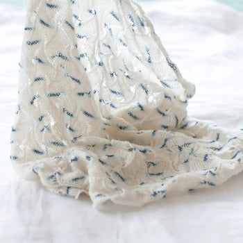 A white with blue flecks cowl made with Cashmere yarn