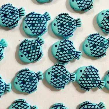 Blue fish-shaped cookies on a light background