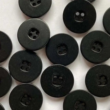 Pattern of black buttons on a white background