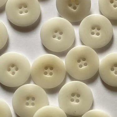 Multiple white buttons arranged in a grid on a light background