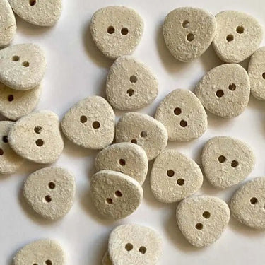 15mm rounded three sided off white cotton buttons (B2) displayed on a surface