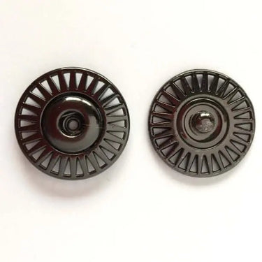 Two black metal pulleys on a white background