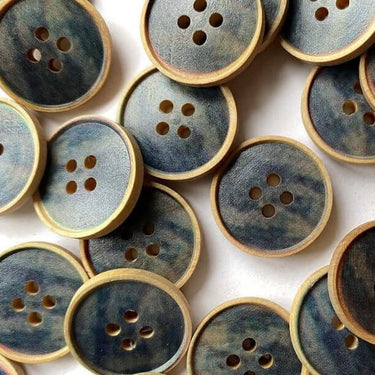 A collection of 20mm streaky blue wood buttons (J5) with a dark blue center, perfect for crafts and sewing projects.