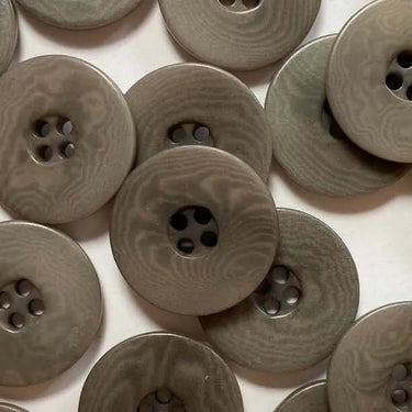 Pattern of brown buttons on a white background