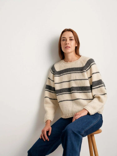 Person wearing a striped sweater from the 52 Weeks of Sweaters knitting book collection, available for pre-order.