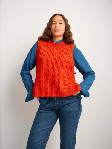Model wearing a vibrant orange knitted sweater, featured in the 52 Weeks of Sweaters book available for pre-order.