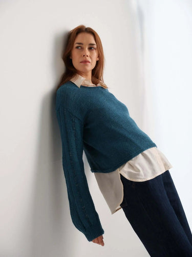 Woman wearing a blue sweater featured in 52 Weeks of Sweaters book for pre-order