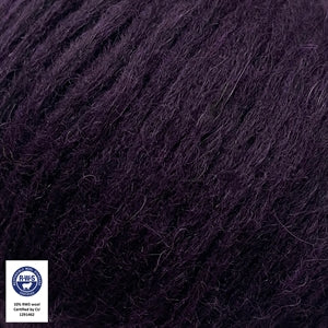 Close-up of Snefnug yarn in dark purple by CaMaRose, featuring a blend of baby alpaca, merino wool, and organic cotton.