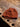 Hand-knitted brown hat on a wooden surface at the Aleks Byrd - Meet & Greet, Book Signing (BOOK INCLUDED) and Trunk Show.