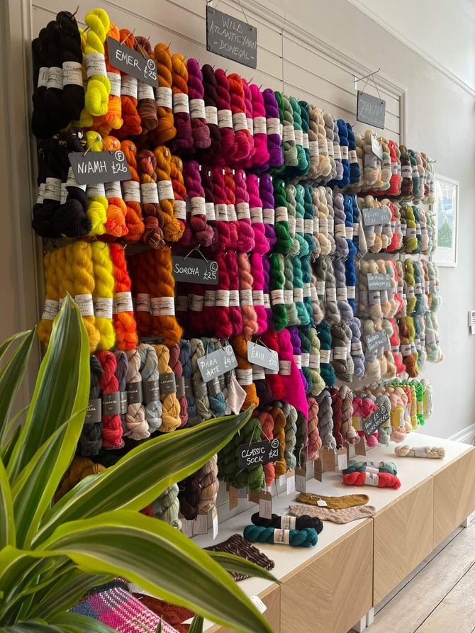 Colourful yarn hanging on wall. Premium wool with all colours.