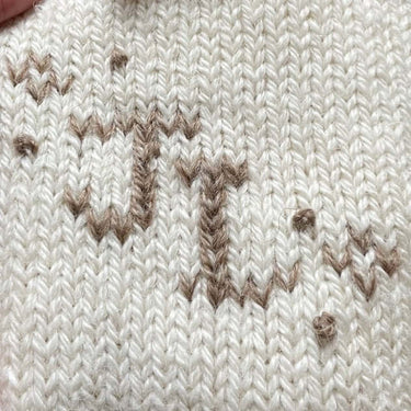 Close-up of Duplicate Stitch embroidery on knitted fabric, showcasing detailed craftsmanship for the embellishment workshop with Justine Lee.