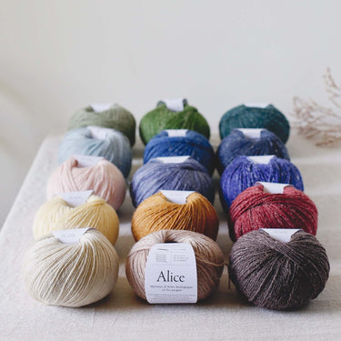 Colorful yarn balls display, Alice | De Rerum Natura blend of organic Mérinos d'Arles and linen, ideal for crafting, button accents
