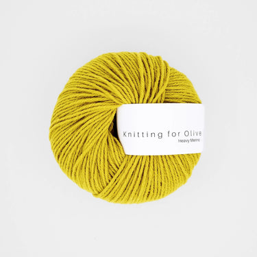 Ball of Knitting for Olive Heavy Merino wool in yellow color on a white background