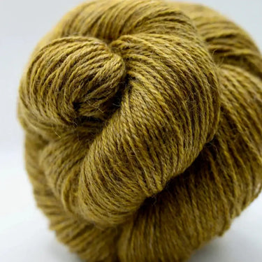 Yarnadelic Sport yarn in a warm brown shade, made from 100% Falklands Corriedale wool, coiled in a cozy skein.
