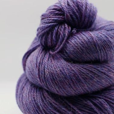 Yarnadelic Sport Falklands Corriedale yarn in purple, ideal for sport hobbies, crafted from a 100-year-old sheep breed blend.