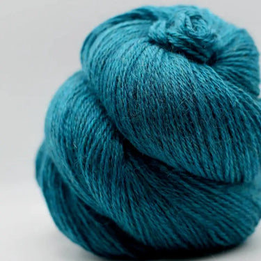 Yarnadelic Sport 100% Falklands Corriedale yarn in teal blue, perfect for knitting and crafting.