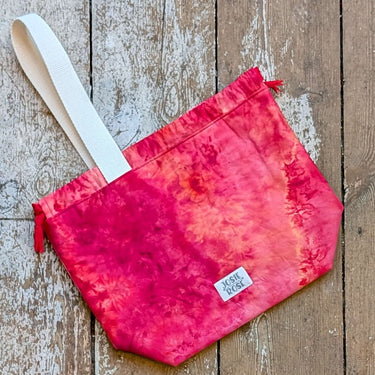 Large ice dyed Jose Rose Craft Project Bag with red and orange colors, featuring a white handle and interior pockets.