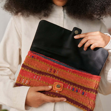 Woman holding a clutch bag with Beaded Colourwork design, showcasing modern knitting techniques with beads by Jeanette Sloan.