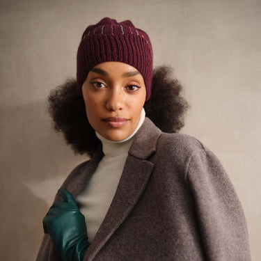 Model wearing a knitted beanie from Beaded Colourwork book collection