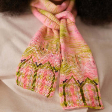 Close-up of knitted scarf with pink and green design using Beaded Colourwork technique, highlighting detailed beadwork.