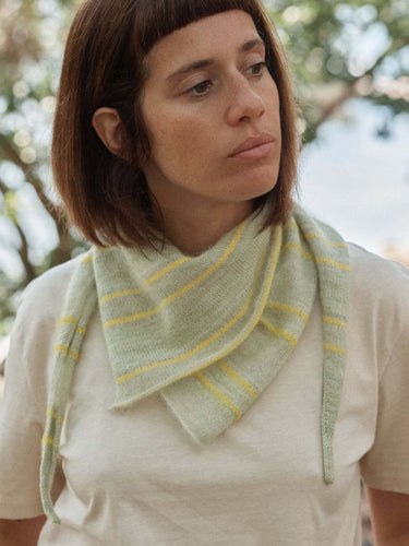 Woman wearing a knitted scarf, featured in Laine Magazine Spring 28 edition.