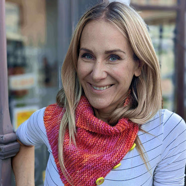 Woman wearing a hand-knitted scarf at Beginner Knitting Class