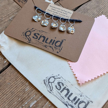Handcrafted recycled 925 Silver Stitch Markers by Snuid on display card with organic shapes.