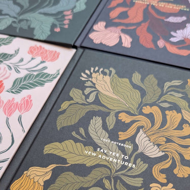 Four Flower Notebook designs with floral motifs by Tytti Laitakari, including Peach Blossom, perfect for jotting project details.