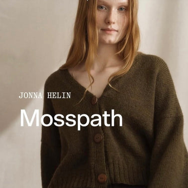 Woman wearing green knit sweater made from Laine x Novita DKfrom Jonna Helin Mosspath collection, showcasing soft wool texture and minimalist design.