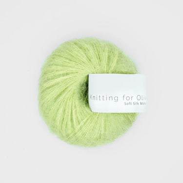 Light green ball of Knitting For Olive Soft Silk Mohair yarn on white background