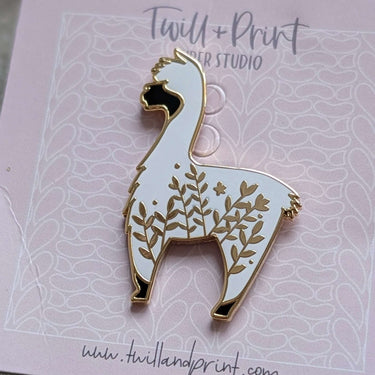 Twill + Print Enamel Pins featuring a white alpaca design, perfect for decorating bags or cases. High-quality smooth, durable enamel.
