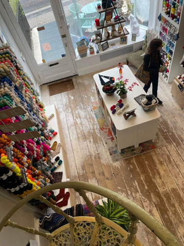London Shop inside looking down on premium yarn hanging on wall