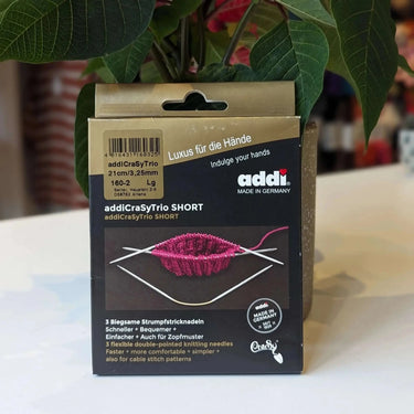 Addi short Knitting Needle packaging on a table with plants in the background at Knit With Me yarn shop
