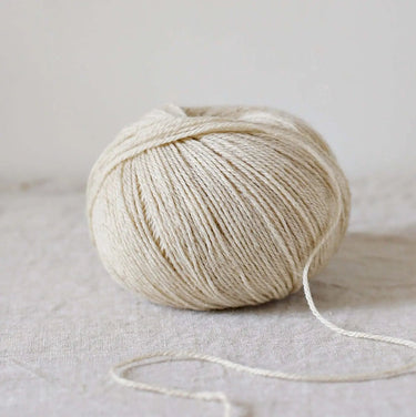 Alice | De Rerum Natura yarn ball featuring a blend of organic Mérinos d'Arles and linen with button for knitting projects