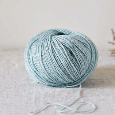 Alice | De Rerum Natura yarn ball, 75% organic Mérinos d'Arles and 25% linen blend; light blue color, soft texture, and elastic quality