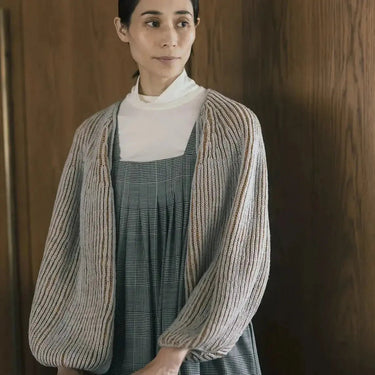 Model wearing top-down sweater from Amirisu Assemblage Vol. 2 collection, showcasing knitting techniques and unique designs.