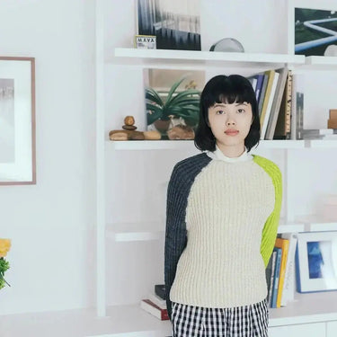 Model wearing top-down sweater from Amirisu Assemblage Vol. 2 collection, showcasing innovative knitting techniques.