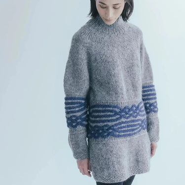 Model wearing a knit sweater from Amirisu Assemblage Vol. 2, featuring a top-down design with intricate patterns.