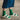 Green knit socks from Amirisu Sock Knitting Club paired with white sandals.