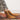 Amirisu Sock Knitting Club textured socks on a colorful rug, showcasing intricate knitting designs for enthusiasts.