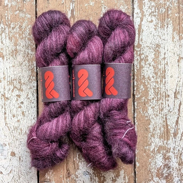 A&P Lace Silk Mohair yarn in rich purple hues, showcasing fluffy hand-dyed kid mohair blended with silk.