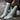 Archipelago Knitting pre-order featuring stylish grey knit socks in cable pattern on feet.