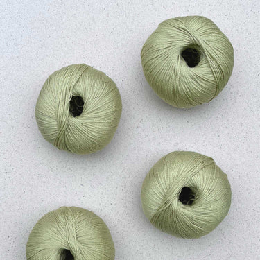 Arctic Pearl vegan eco-friendly yarn balls made from 100% Lyocell fibers, featuring eucalyptus and brown seaweed blend for skin benefits.