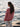Model wearing striped knitwear from Art of the Sea collection by Laine, inspired by the Moomins, standing by the ocean.