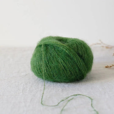 Bérénice lace weight yarn in green, made from extra-fine Angora goat fibres and organic Merinos d'Arles, spun with shiny silk yarn.