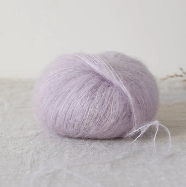 Bérénice lace weight yarn in pastel lavender, made from fine Angora goat fibres and organic Merino wool, showcasing a soft texture.