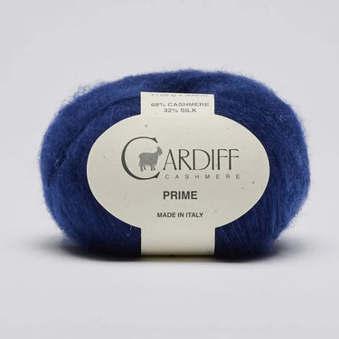 Blue skein of yarn with a Cardiff Cashmere label on a light gray background