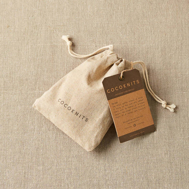Cocoknits Sweater Care Brush package with natural bristle brush for textile rejuvenation and lint removal.