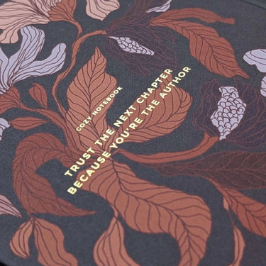 Flower Notebook with floral motifs by Tytti Laitakari, showcasing the quote "Trust the next chapter because you're the author."