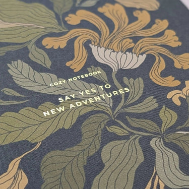 Flower Notebook with floral motifs and 'Say Yes to New Adventures' text on cover.
